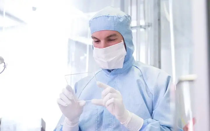 Scientist examining a piece of glass in the laboratory