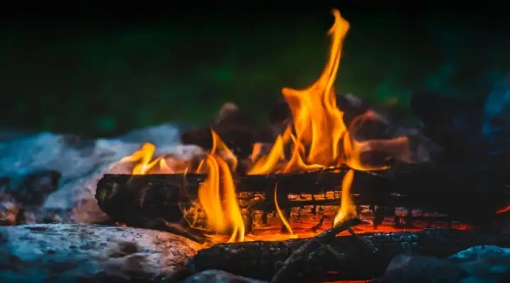 Burning logs on a campfire at night