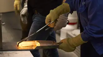 A SCHOTT employee working with the melted glass