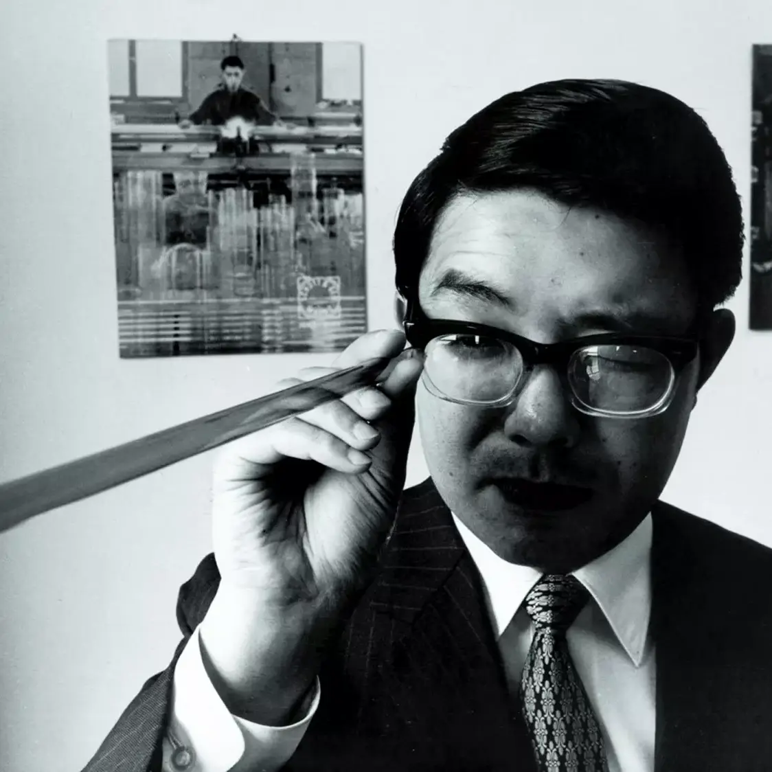 Man looks down a glass tube in a Tokyo office