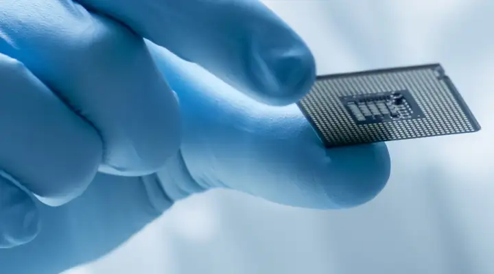 Hands holding a glass slide in a research laboratory