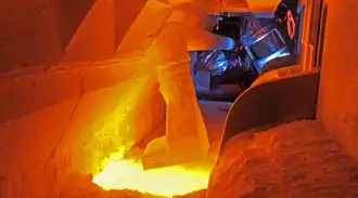 Look into a melting tank where raw materials are melted into glass