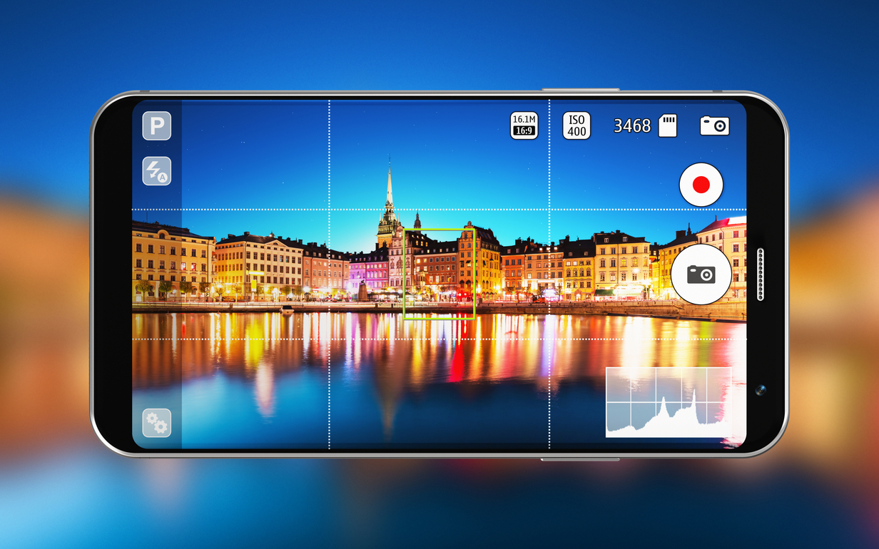 Smartphone with a photo of a city at night reflected in the water.