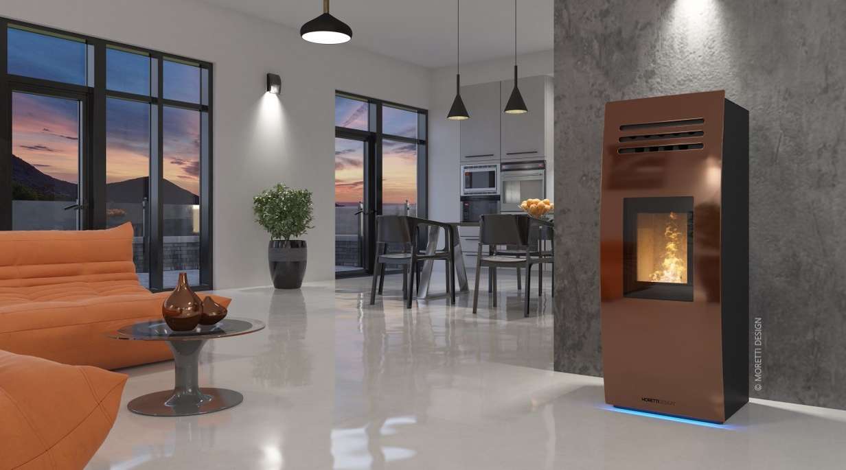 Bronze DREAM pellet stove by MORETTI Design in a scenic atmosphere with SCHOTT ROBAX® NightView fire-viewing panel