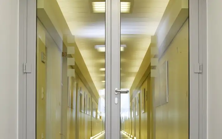 Glass double door with long corridor behind