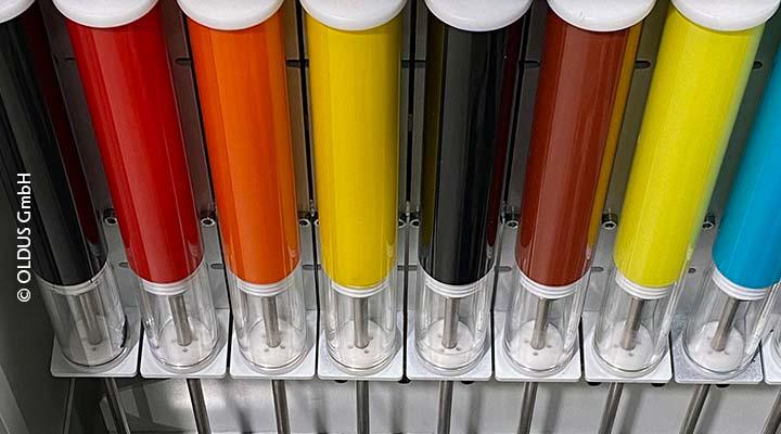 Row of glass tubes containing paint of different colors