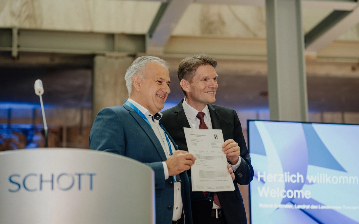 District Administrator Roland Grillmeier hands over the permit for the new electric melting tank to SCHOTT CEO Dr. Torsten Derr.