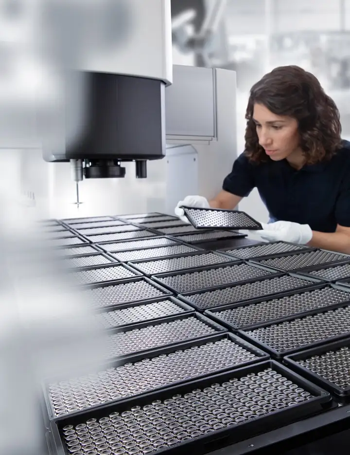 Worker checking glass to metal