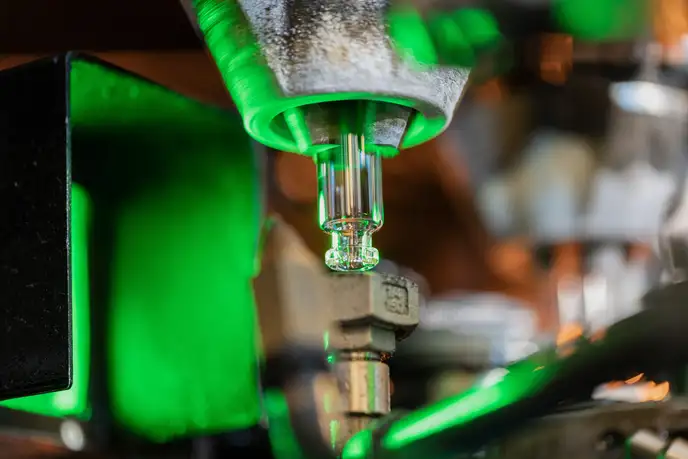 Clear glass vial being produced using the 3D hot forming process