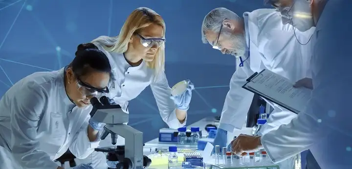 A team of technicians examine samples in a laboratory