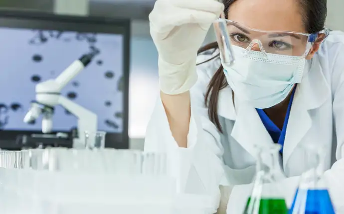 Female scientist examining a test tube in a laboratory