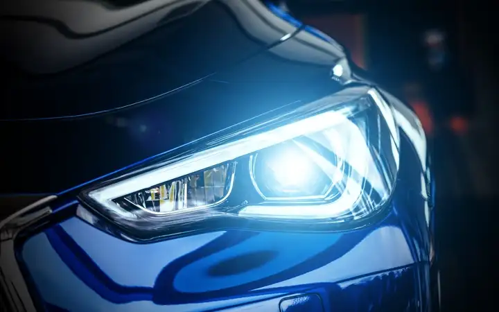 Headlight of a blue luxury sports car