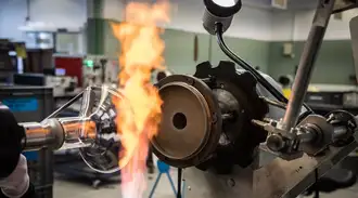 A glass tube being heated to be widened