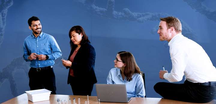 Group of young people in business clothing talking in a meeting room