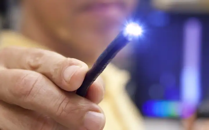 Medical flexible light guide and LED held by a male hand