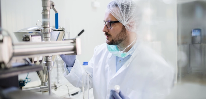 Scientist in lab looking at primary packaging
