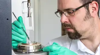 Scientist works on an electrolysis cell 