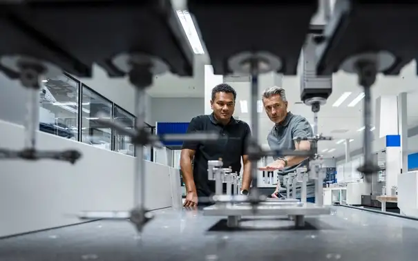Engineers_discussing_over_machinery_at_factory_mit_logo.jpg