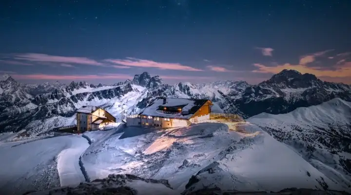 Mountain landscape at sunset with mountain lodge 