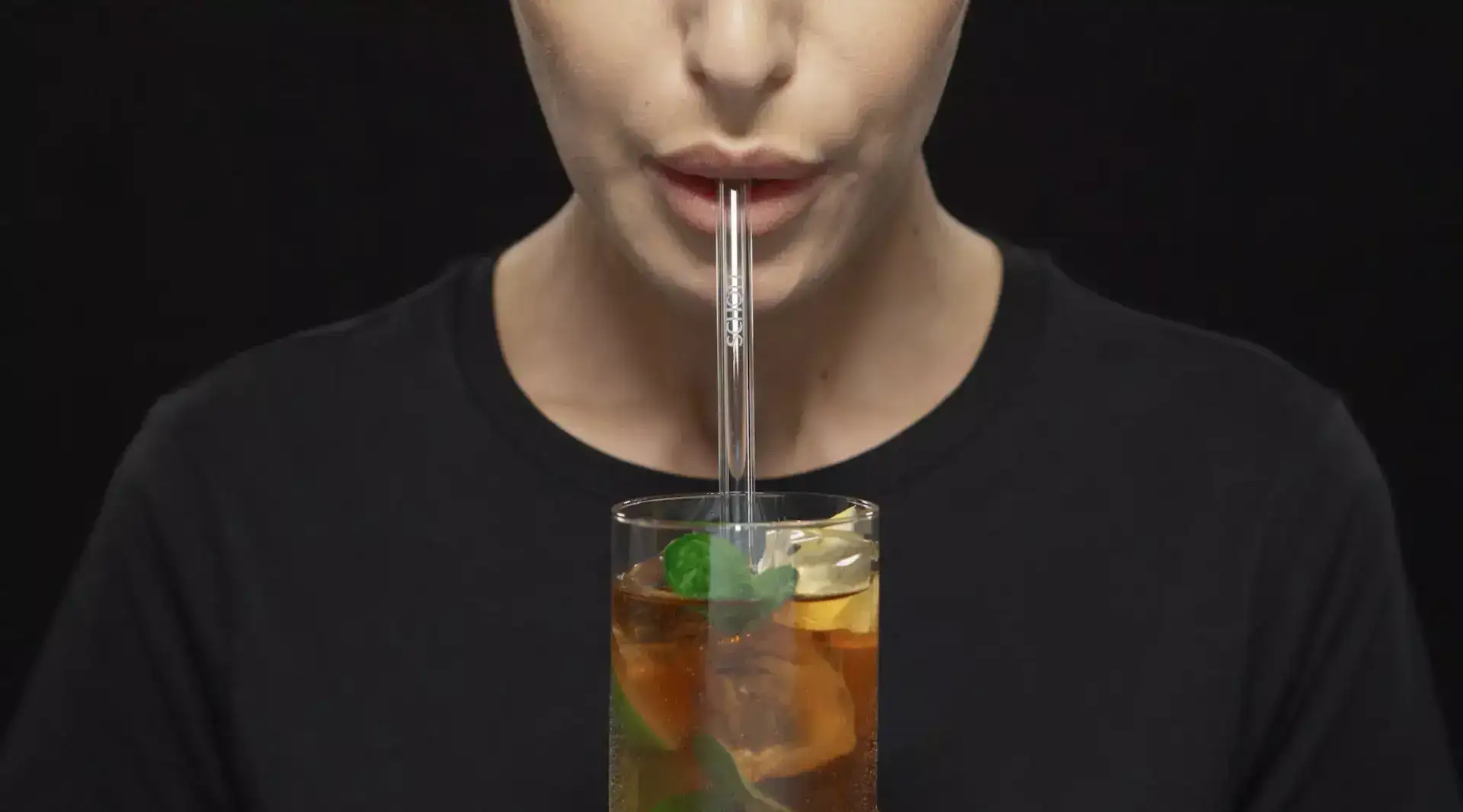 Female drinking drink through a glass straw	