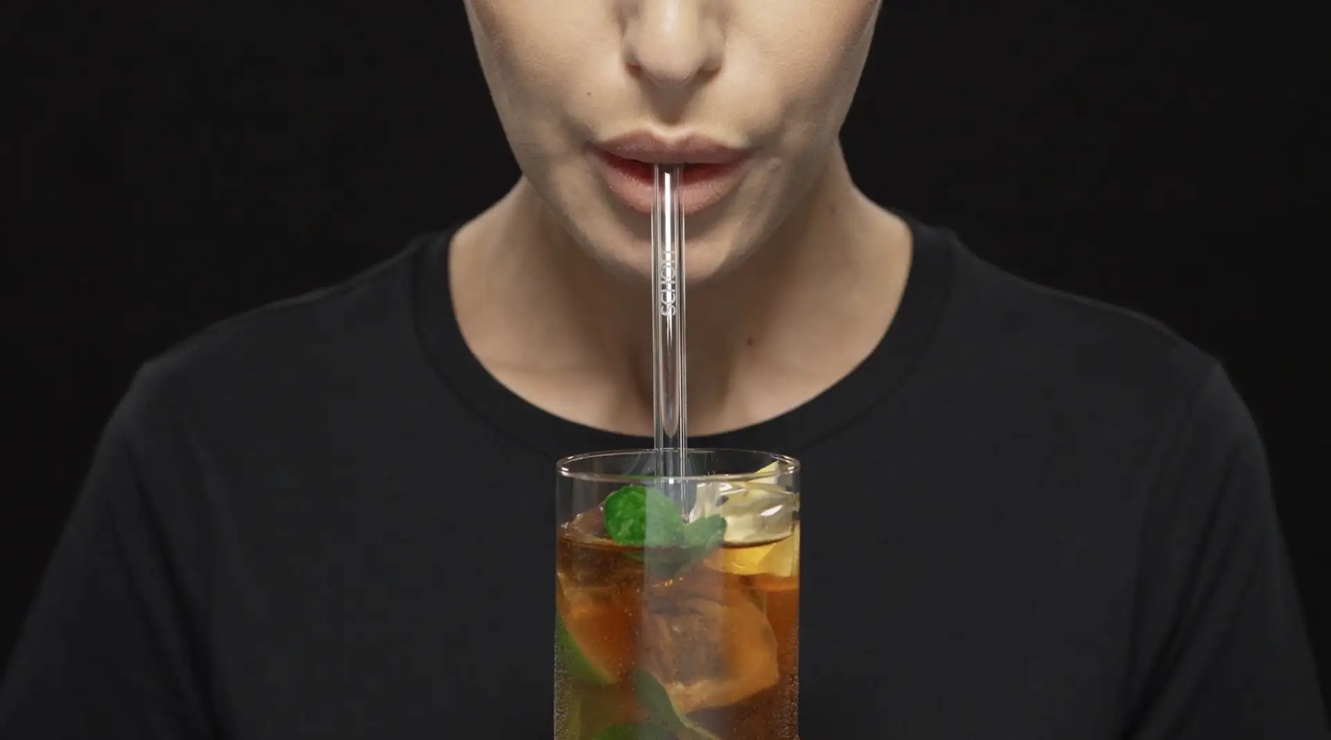 Female drinking drink through a glass straw	