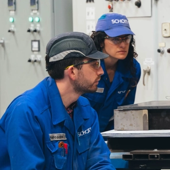 SCHOTT employees checking quality of laser glass melt