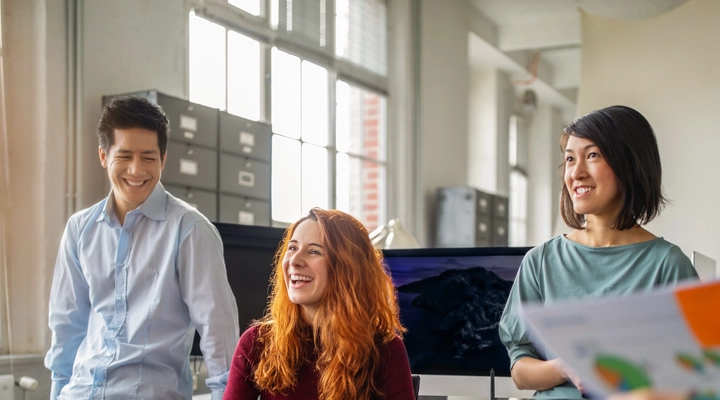 Three young people in an office meeting