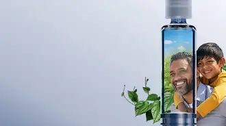 A glass syringe infront of a man and young boy.