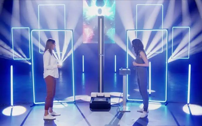 Woman stands for drop test machine at a virtual product launch event