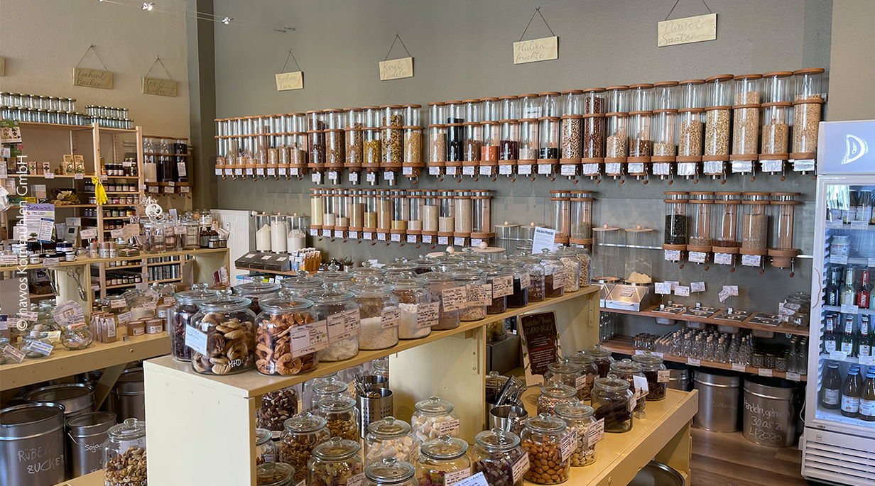 	 A hawos unpacked store with glass tubes and jars containing dry goods 