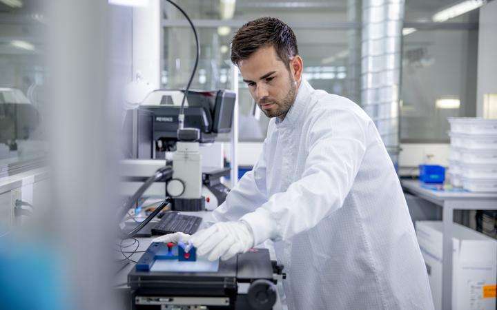 Laboratory technician sets up analysis equipment