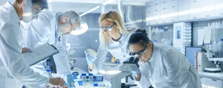 Scientists in a laboratory use Microscope, Test Tubes, Micropipette