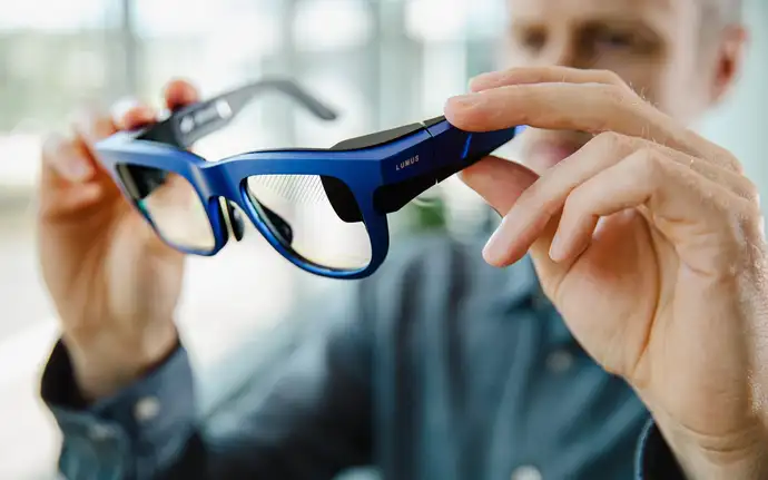 Ein Mann hält den Prototyp einer Lumus AR-Brille in der Hand.