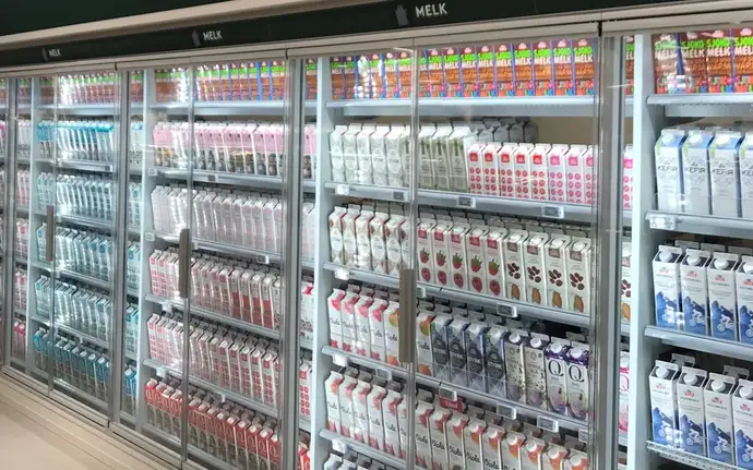 Row of chiller cabinets filled with milk in a Cold Room fitted with SCHOTT Termofrost® glass door systems