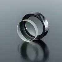 Clear spherical lens and lens assembly for camera system on grey background