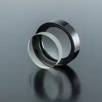 Clear spherical lens and lens assembly for camera system on grey background