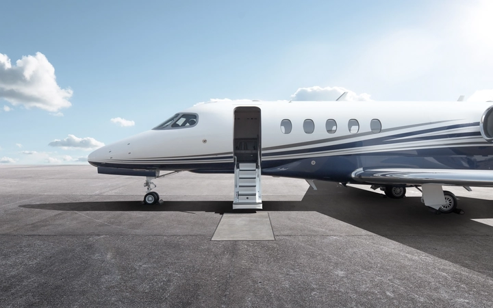 Private jet on the runway with its door open and steps out