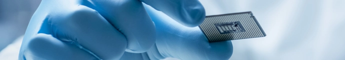 Hands holding a glass slide in a research laboratory