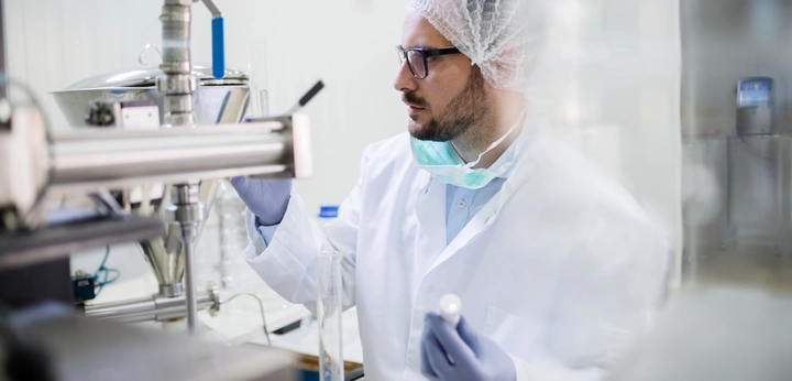 Scientist in lab looking at primary packaging