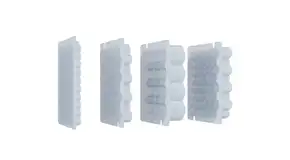 Four transparent plastic trays containing aligned compartments, seen isolated on a white background.