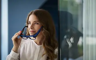 Female putting on a pair of augmented reality (AR) smart glasses