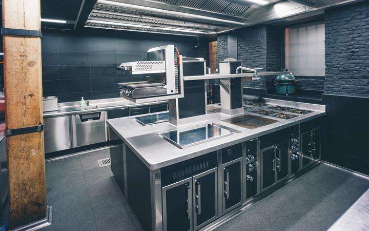Modern professional kitchen with a range of cooktops and ovens