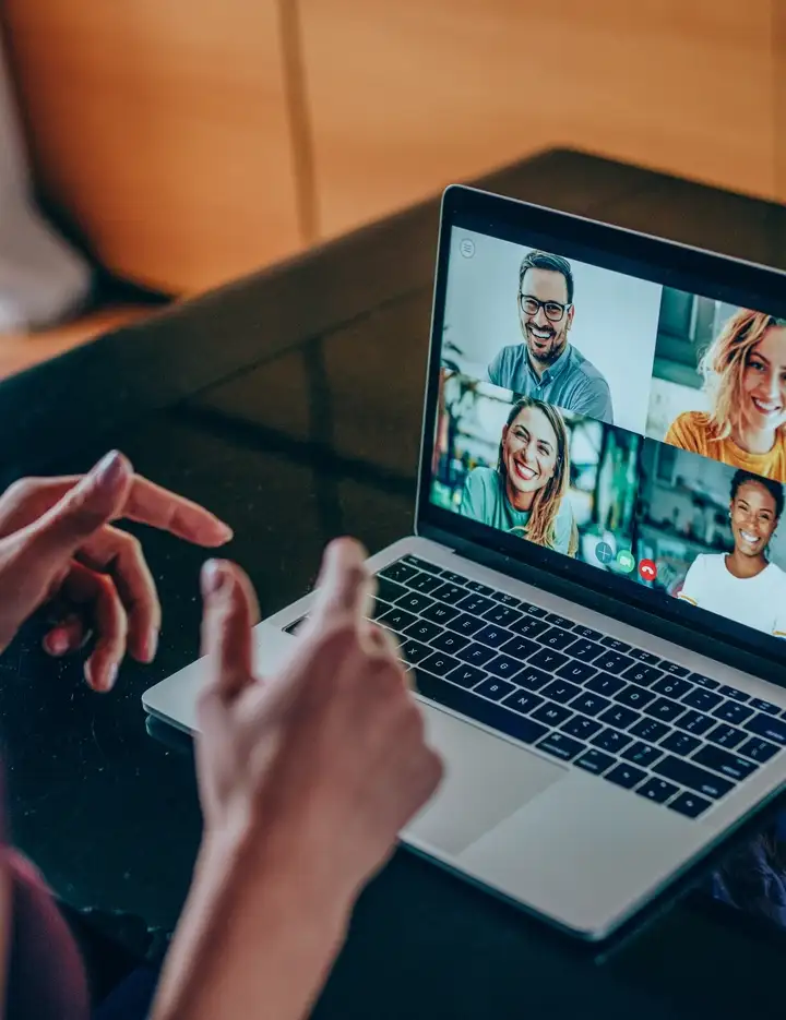 Female participating in an online meeting on a laptop