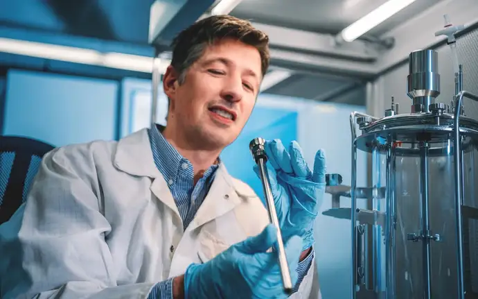 Scientist inspecting a Raman spectrometer