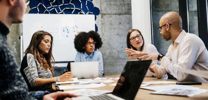 Young male and female office workers having discussion in meeting room