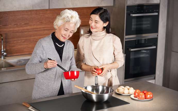 Mother and daughter cooking together in a modern kitchen