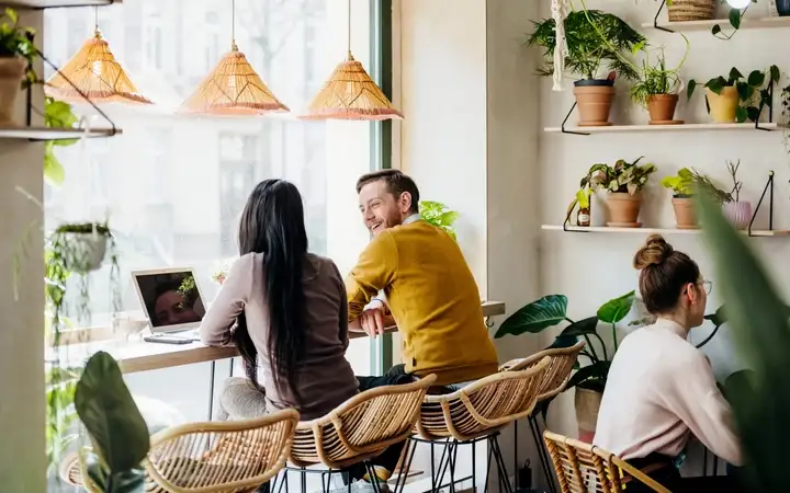 Two young people having a conversation in a cafe