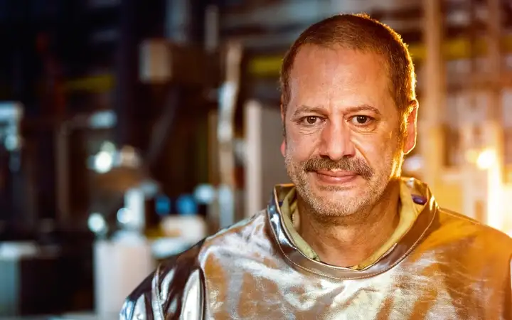 Man in silver fire-resistant protective suit