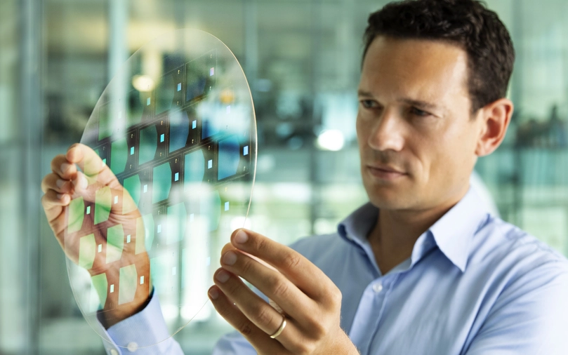 Man looks at augmented reality glass wafer from SCHOTT